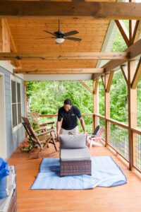 Gasperson mover preparing to carefully wrap up an outdoor chair on a residential patio