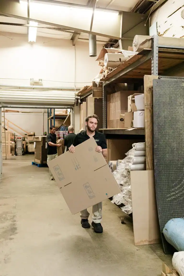 Mover carrying cardboard in warehouse