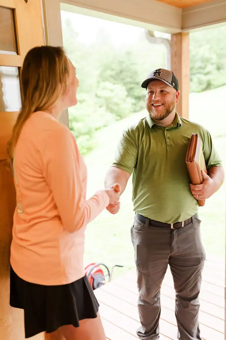 Gasperson mover shaking hands with resident