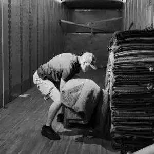 Gasperson mover lifting item in moving truck